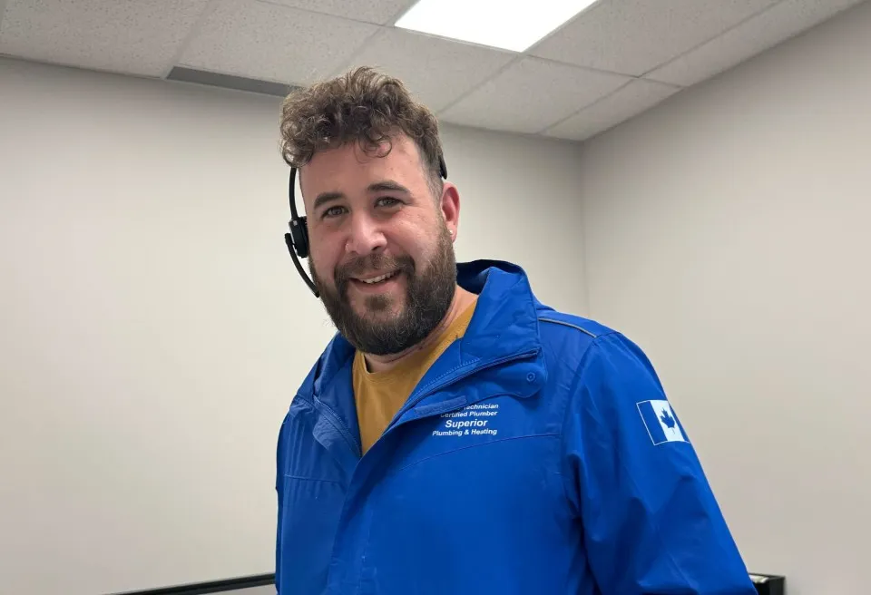 A Superior Plumbing & Heating team member wearing a headset in the office