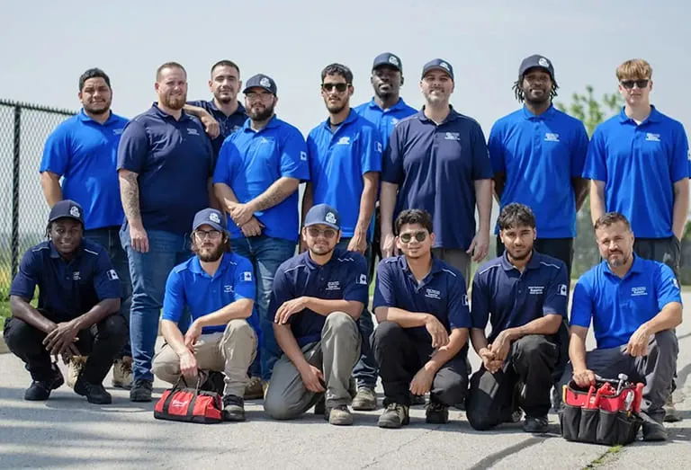 The Superior Plumbing & Heating team in company shirts, with their tool bags
